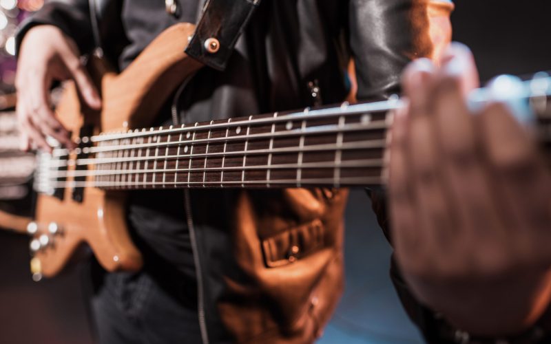 Close-up partial view of rock star playing hard rock music on stage